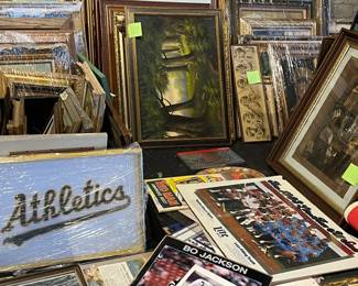 Large assortment of framed artwork, prints, photographs, and posters stacked and ready for browsing. Includes landscapes, decorative prints, vintage photographs, and sports ephemera in a variety of frames and styles. A true treasure-hunt selection ideal for collectors, decorators, and resellers. All items sold as-is.