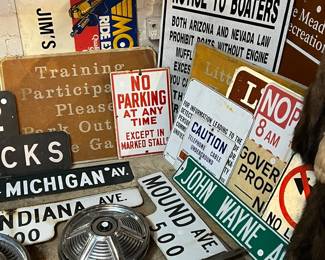 Bold collection of vintage metal signs and industrial ephemera featuring street signs, parking notices, railroad and boating warnings, and advertising graphics. Includes pieces from various cities and eras with strong typography, graphics, and authentic wear. Ideal for collectors, decorators, garages, or retail display. All items sold as-is.