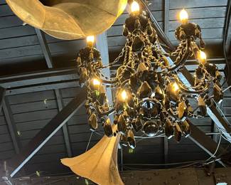 Elegant Schonbek crystal chandelier featuring cascading faceted prisms, scrolling crystal arms, and candle-style lights. Renowned for exceptional craftsmanship and brilliance, this chandelier offers timeless luxury and dramatic sparkle. Ideal for refined interiors or statement lighting. Condition consistent with age. All items sold as-is.