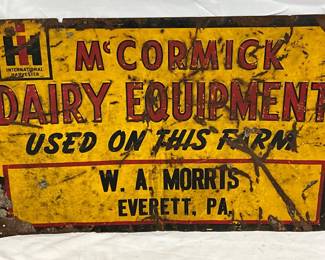 Embossed Metal McCormick Dairy Equipment Advertising Sign, 23in x 14 1/2in