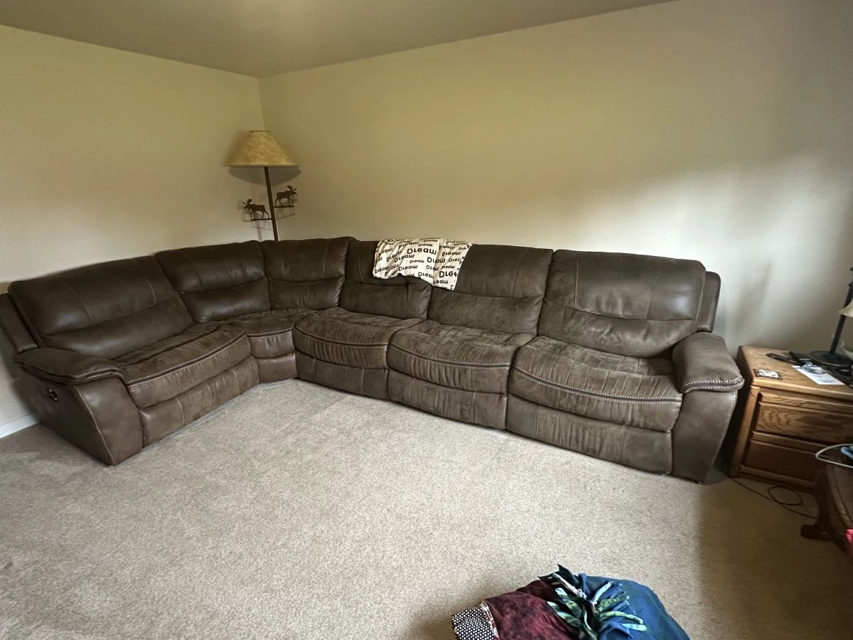 Sectional couch as good as new shape. Electric recliners on each end and one manual recliner. Side table.