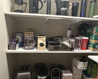 Assorted kitchen appliances, coffee makers, coffee grinder.