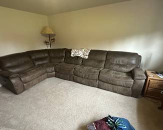 Sectional couch as good as new shape. Electric recliners on each end and one manual recliner. Side table.