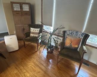 Antique chairs, cabinet, dehumidifier, and plant.