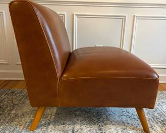 R27 - $175. Huxley Mid Century Style Armless Chair. From World Market (Retail $599) Needs leather conditioner but no holes / rips / tears. Measures 31.5" wide x 30.25" deep x 30" tall.