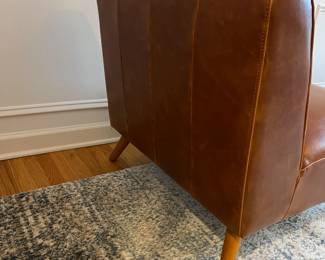 R27 - $175. Huxley Mid Century Style Armless Chair. From World Market (Retail $599) Needs leather conditioner but no holes / rips / tears. Measures 31.5" wide x 30.25" deep x 30" tall.
