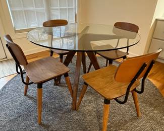R36 - $600 SET. CB2 Table Measures 4' across x 30.25" tall. 4 Vega Dining chairs in very good vintage condition! Purchased over 20 years ago at a boutique furniture store in CT. Glass has some minor scratches from use but very good condition.