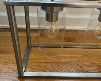 R15 - $50. Pendant Light. Measures 41" wide x 8.5" deep x 35" tall. Brushed Nickel. Works just switched out for a different style.