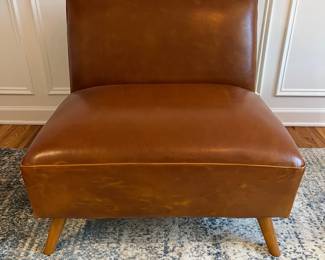 R27 - $175. Huxley Mid Century Style Armless Chair. From World Market (Retail $599) Needs leather conditioner but no holes / rips / tears. Measures 31.5" wide x 30.25" deep x 30" tall.