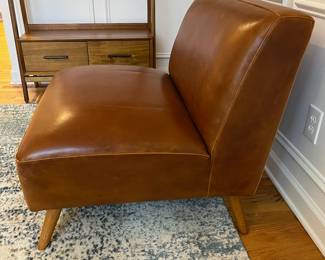 R27 - $175. Huxley Mid Century Style Armless Chair. From World Market (Retail $599) Needs leather conditioner but no holes / rips / tears. Measures 31.5" wide x 30.25" deep x 30" tall.