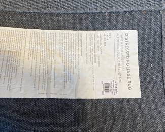 R49 - $150. West Elm Distressed Foliage Rug. Measures 5' x 8'.