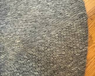 R39 - $50. 7' Round Wool Safavieh "Marbella" Rug. Does show some signs of wear but lots of life left!