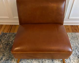 R27 - $175. Huxley Mid Century Style Armless Chair. From World Market (Retail $599) Needs leather conditioner but no holes / rips / tears. Measures 31.5" wide x 30.25" deep x 30" tall.