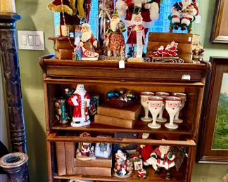 antique barrister bookcase full of vintage and modern Santas.  Jim Shore, vintage shiny bright ornaments.