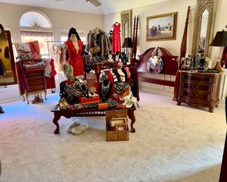Large master full of clothing, shoes, furniture, and costume jewelry.