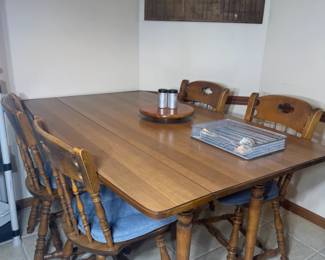 wooden drop-leaf dining table with 4 spindle-back chairs