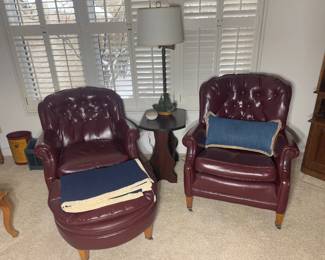 his and hers vintage burgundy tufted leather armchairs with ottoman