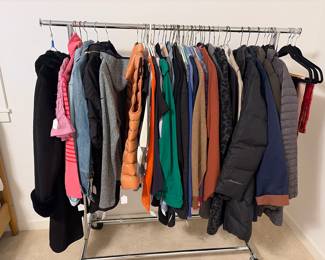 Designer and other clothing for sale during in-person shopping 