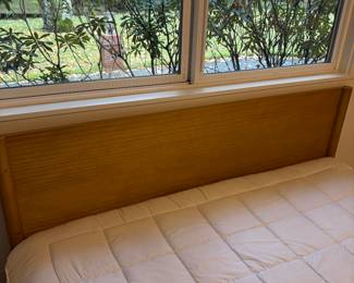 Close up of the headboard.   Wood frame queen bed and mattress. 61”w x 35”h. Available for online and in person purchase.