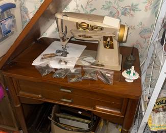 Singer Slant-o-Matic Rocketeer sewing machine in cabinet