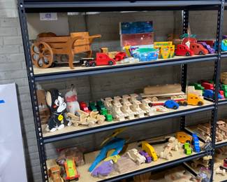 Wood toy cars, some finished and some not