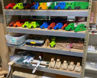 Wood toy cars, some finished and some not