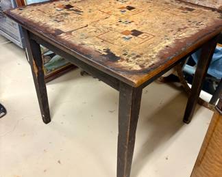 $200 - Antique/vintage card/game table with a detailed folk art linoleum top. 