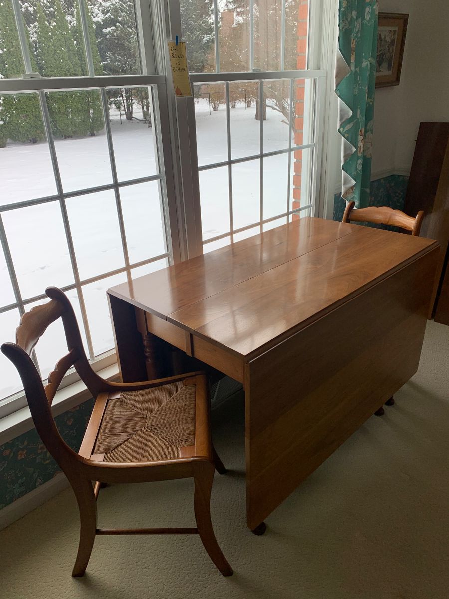 Beautiful drop leaf…I believe it’s walnut…with 6 rush seat chairs…three leaves and all the pads…pristine condition!