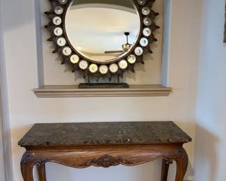 Heckman Marble Top Console Table with a carved apron trim. Crown Sunburst Mirror from Ballard Designs