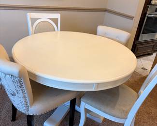 Round kitchenette table with four chairs 