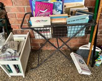 Patio room - basket & books, white wooden book holder with items 