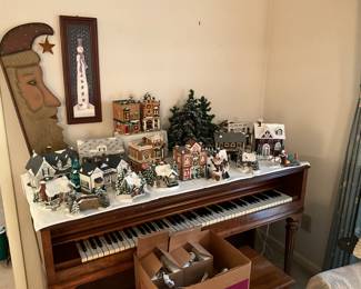 Living room has piano & lots of collectible Christmas villages and more. 