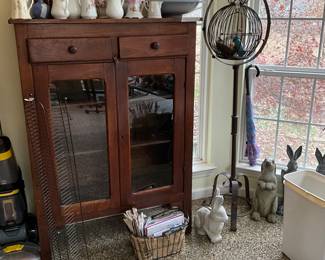 Patio room - Cd/DVD wire holder, lovely vintage cabinet with glass doors, collection of various pitchers on top of cabinet, outdoor rabbits, great metal birdcage 