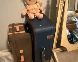 Doll on suitcases 