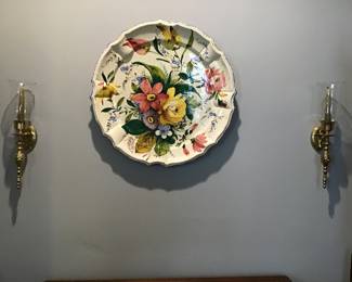 brass sconces and large floral charger