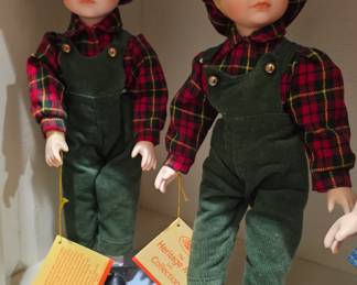 A "Heritage Mint Collection" porcelain boy doll named Adam.