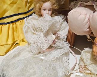 A vintage porcelain bride doll with blonde hair and lace gown