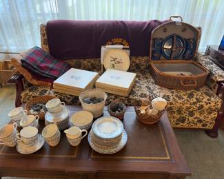 Pretty dishes, leather top coffee table, 7 Boehm bird plates, picnic basket, vintage blankets, vintage flowered couch