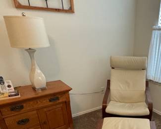 Bentwood chair and ottoman with leather cushions, stained glass window, small oak table