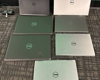 A group of seven laptops