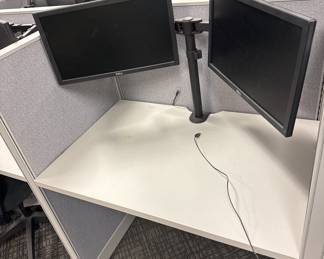 Hundreds of monitors with brackets. The brackets just attached to the desk with one knob. It is very easy 
