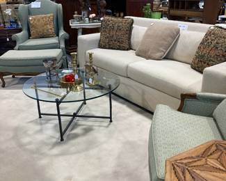 Large sofa, glass top round coffee table, wing chair and ottoman, throw pillows