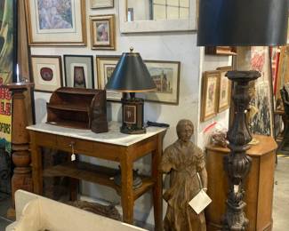 Hall table with marble top, wood sculpture wood floor lamp, art work, cream color wall shelf