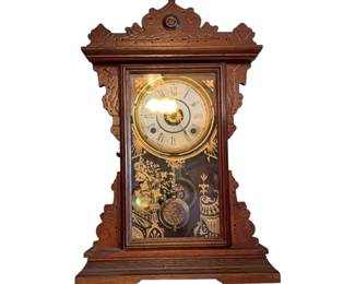 Ornate wooden mantle clock, likely by En Welch. Circa 1880 to 1890.
