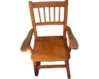 A vintage wooden child's or doll's chair with a spindle-backed and armrest chair. Mid 20th century.