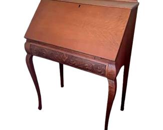 Antique carved oak slant-top secretary desk with cabriole legs. Circa 1900-1920