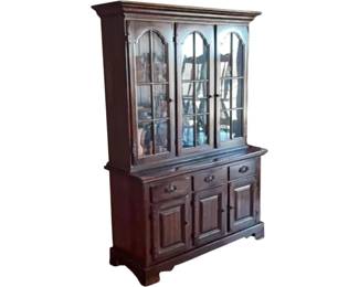 Traditional dark wood China cabinet with glass doors and panel lower cabinets. Circa late 20th century.