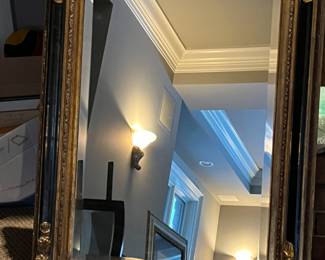 black and gold framed mirror