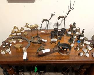 More antiques including bells, weights, and sculptures