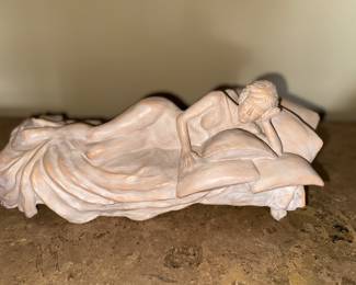 Vintage sculpture depicting a female in repose